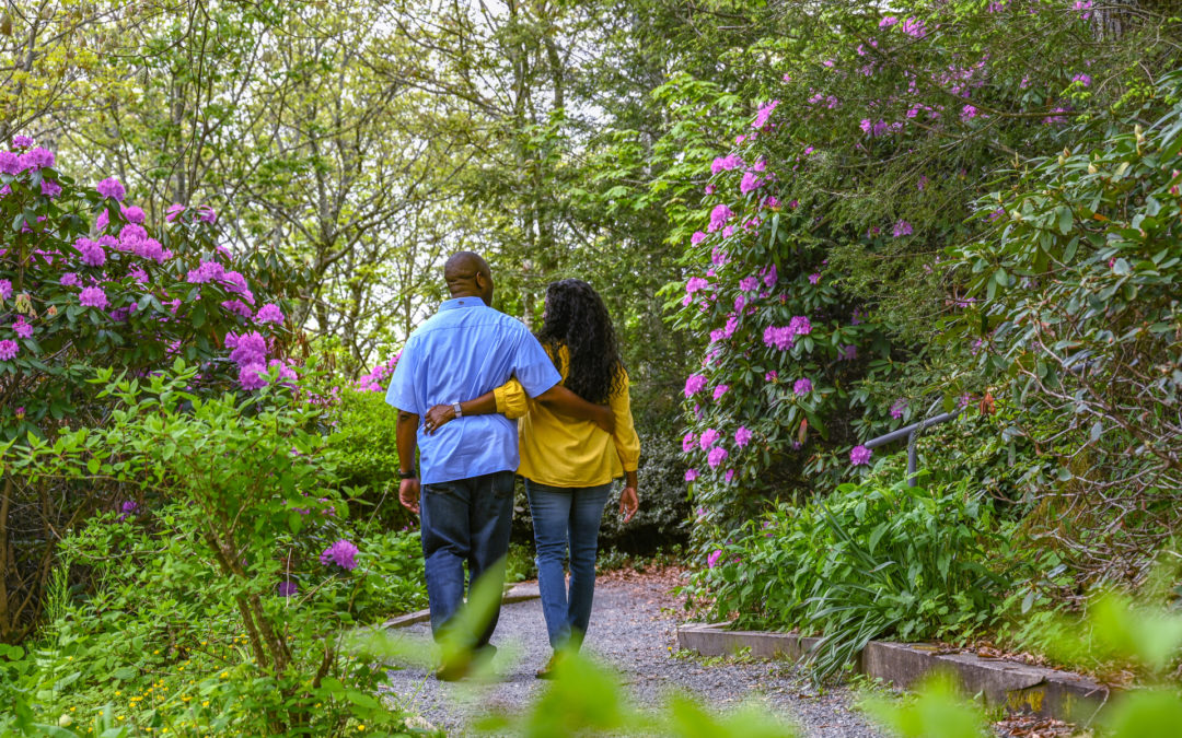 couple hiking at the blowing rock attraction with purple rhododendron