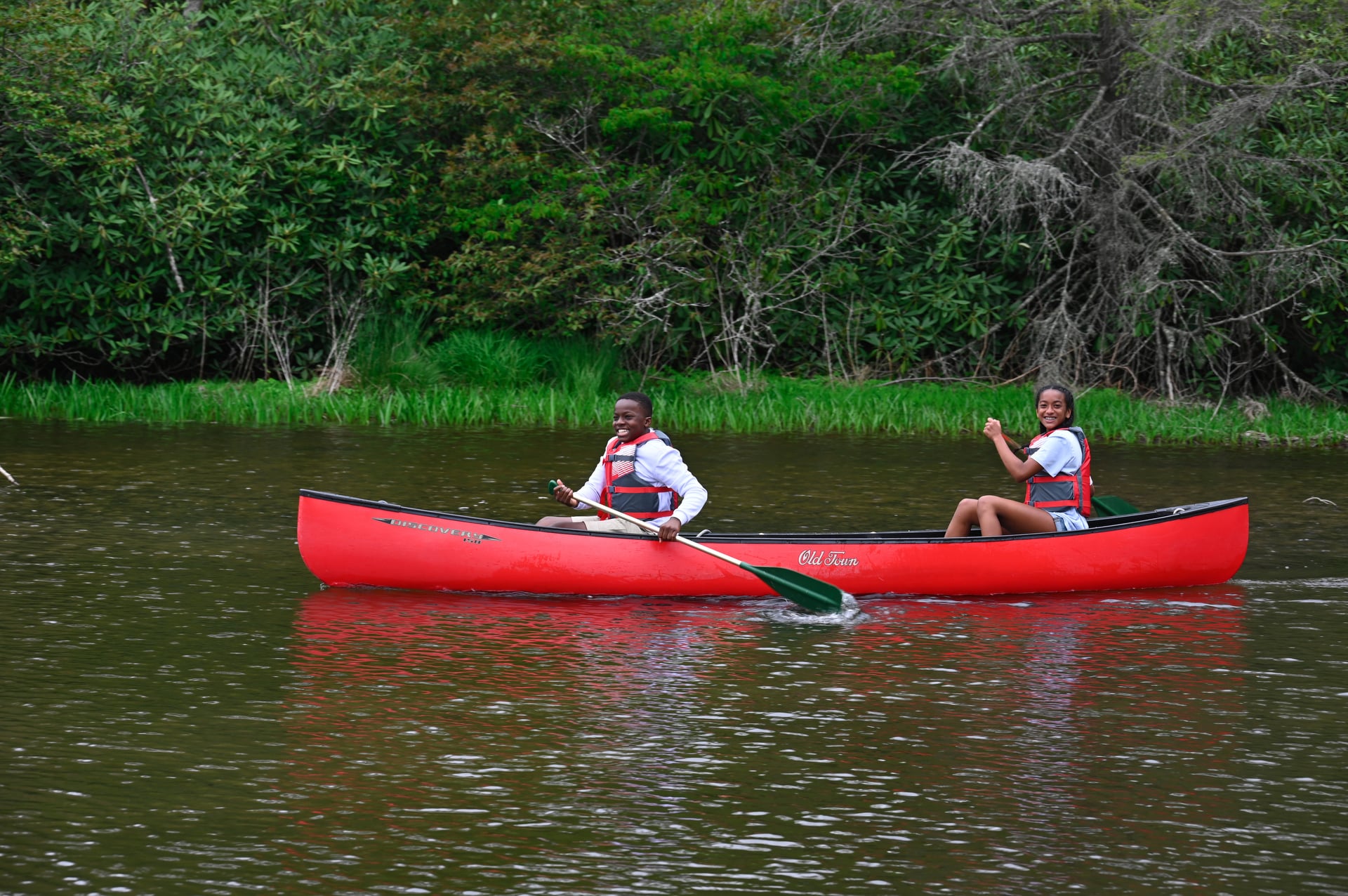 teenagers kayaking on price lake