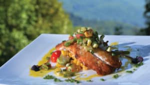 A dish of mountain trout at the Restaurant at Gideon Ridge, with a bright garnish of seasonal vegetables.