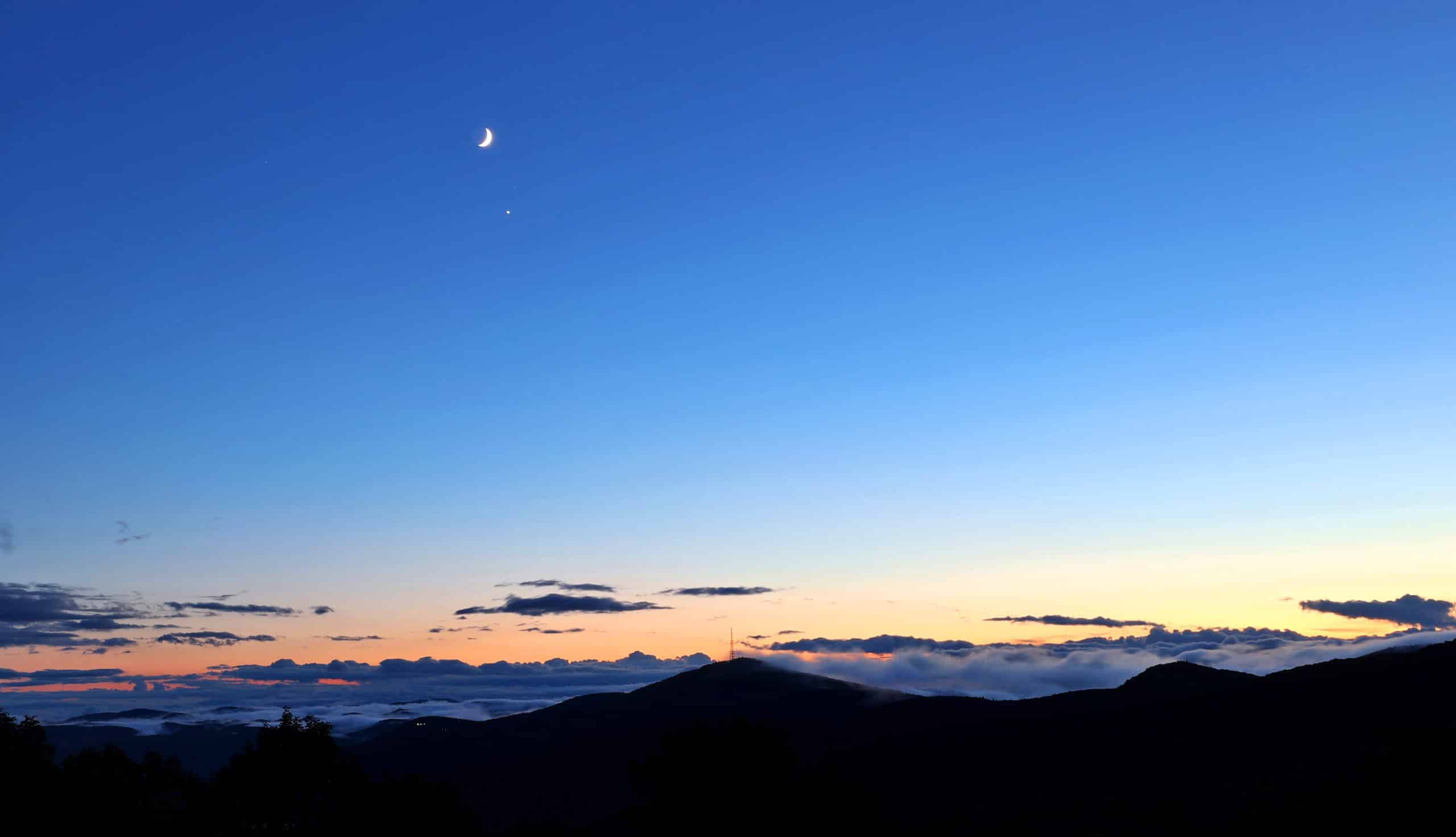 Moon and venus over Blue Ridge Mountains near blowing Rock