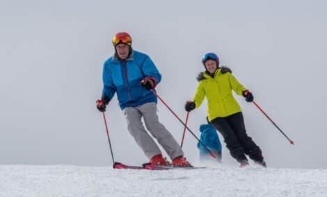 Couple skiing on snow