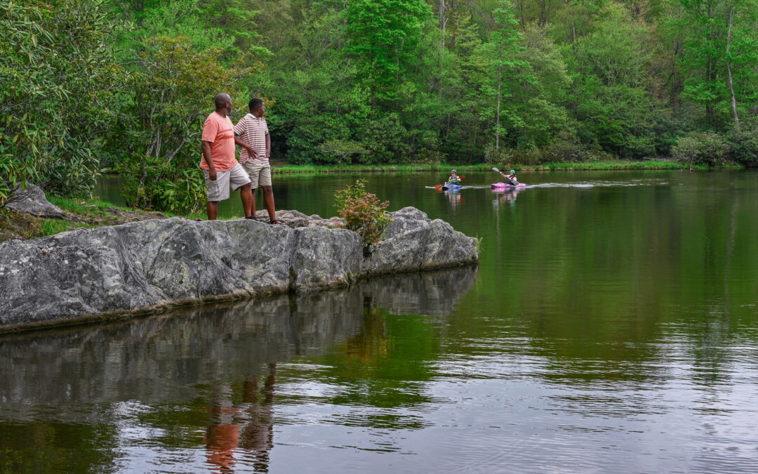 outdoor family and kayakers at a lake
