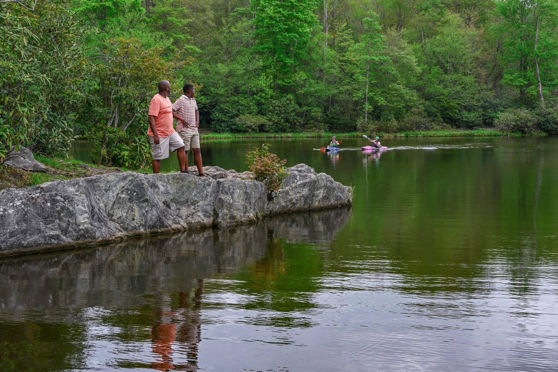 outdoor family and kayakers at a lake