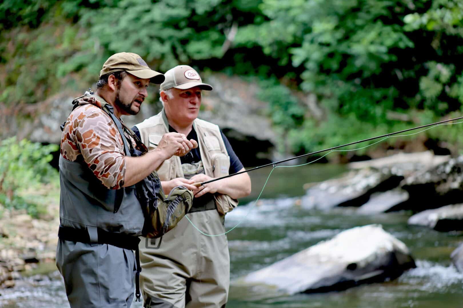 fly-fishing guide with fisher on river