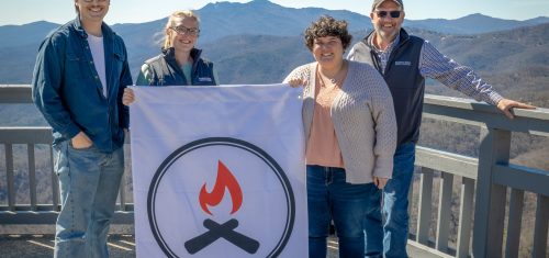 Pictured: Blowing Rock TDA staff with a Unity Blaze banner at The Blowing Rock Attraction